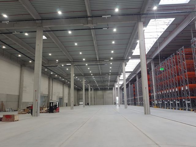 A warehouse interior with rows of LED high-bay lighting