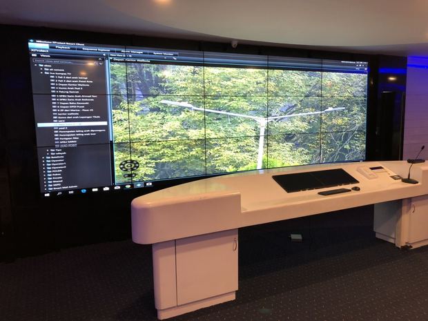 A control room with a video wall and operator consoles