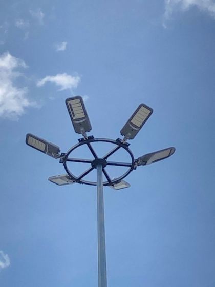A high-mast tower with a crown of LED floodlights